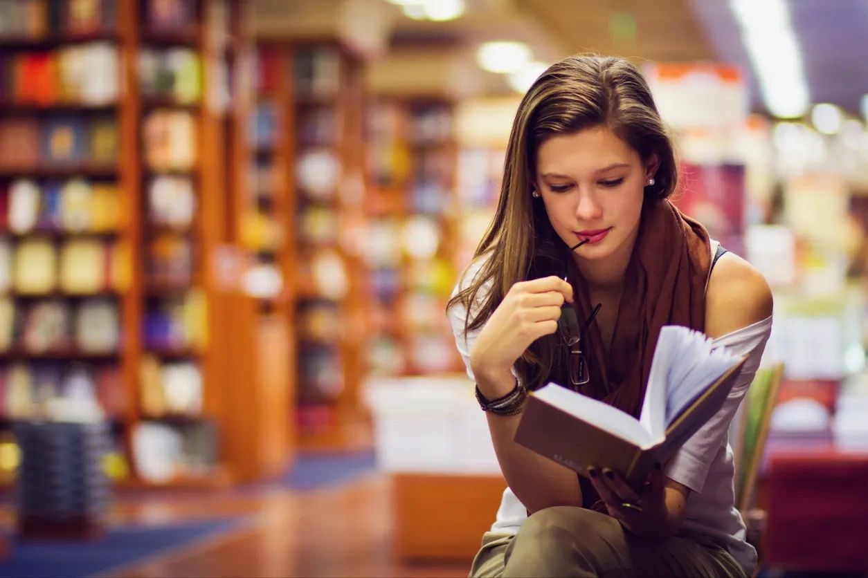 Woman reading a book in a bookstore