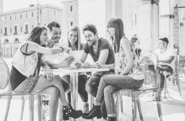 Young adults gathered at a cafe table